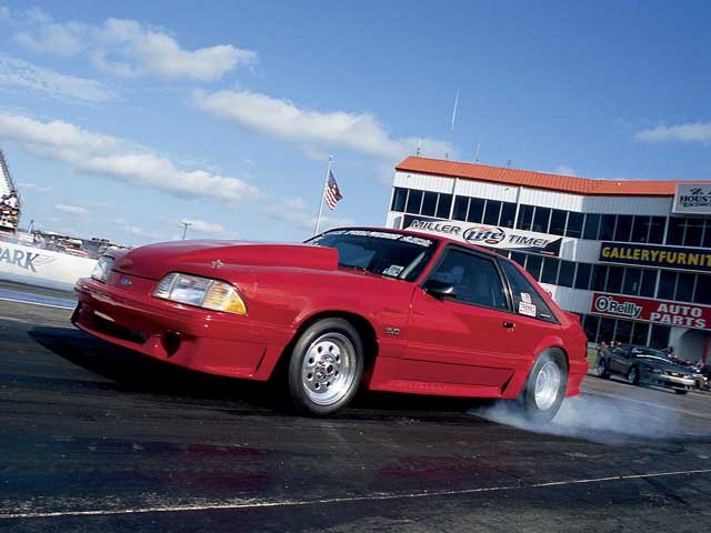 Mmfp_0509_03z 1993_Ford_Mustang_GT Front_Drivers_Side_View_At_Track