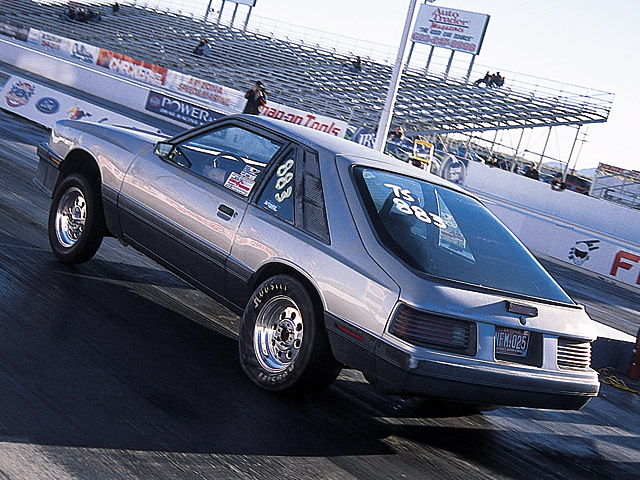 0405mm_37z 1986_Ford_Mustang Rear_Drivers_Side_View_At_Track