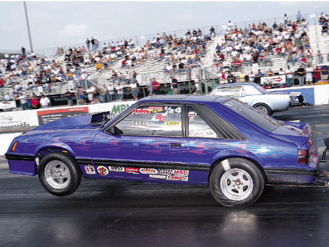 0310mm_13z 1983_Ford_Mustang Drivers_Side_View_At_Track