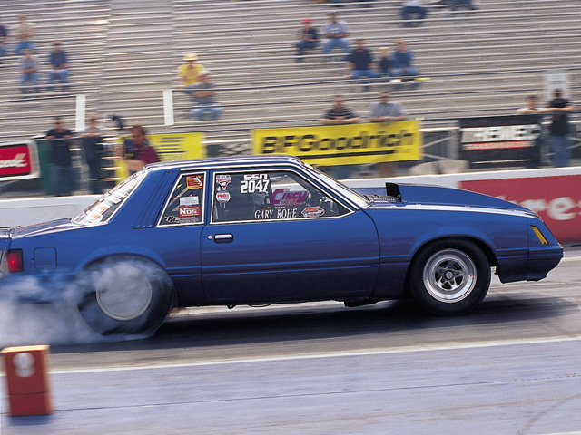 0310mm_12z Ford_Mustang Passenger_Side_View_At_Track