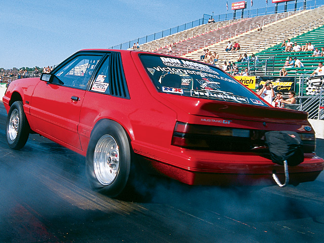0412mm_05z 1985_Ford_Mustang Rear_Drivers_Side_View_At_Track